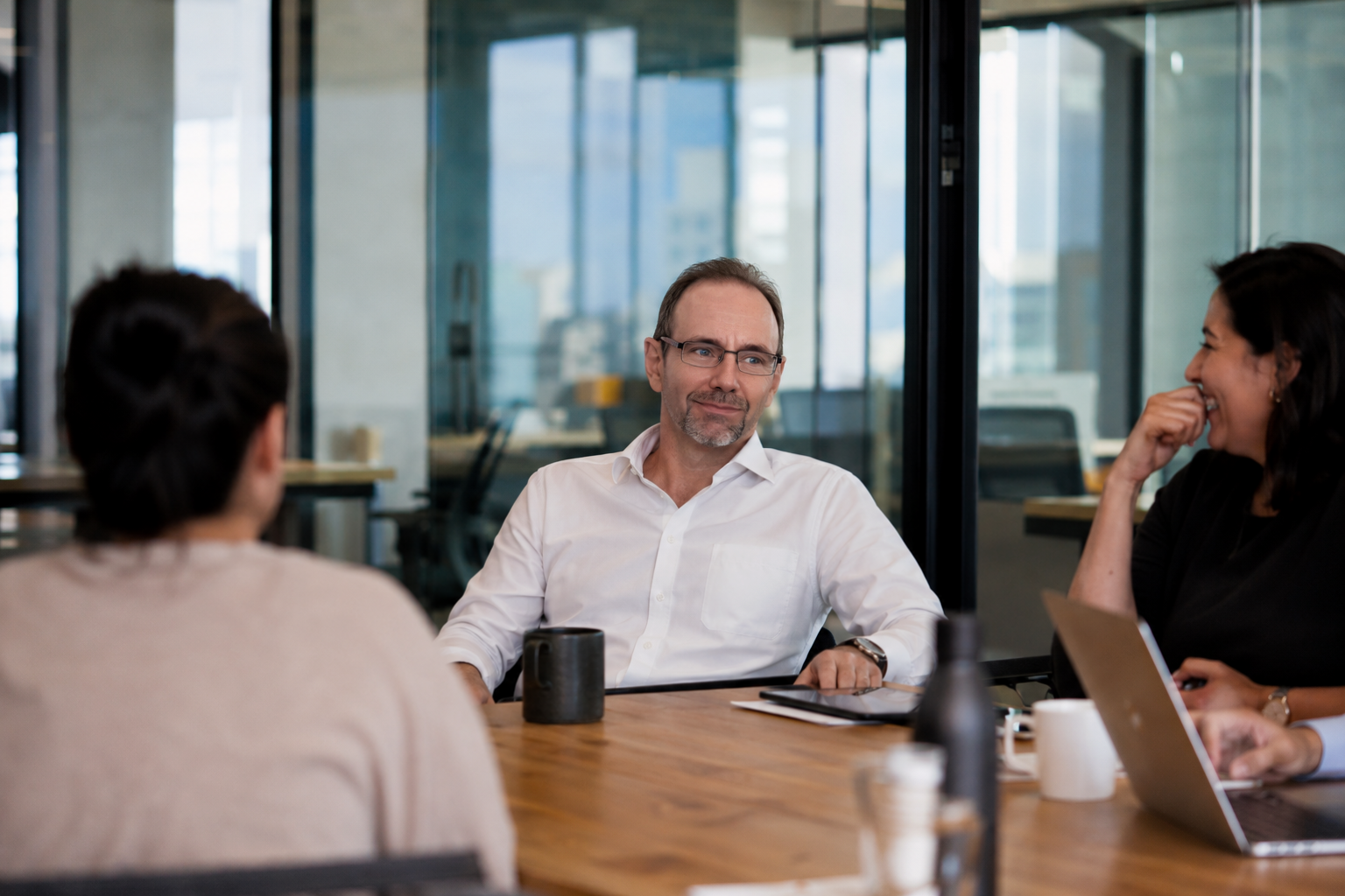 Dr. Basso in conversation with colleagues in a modern office